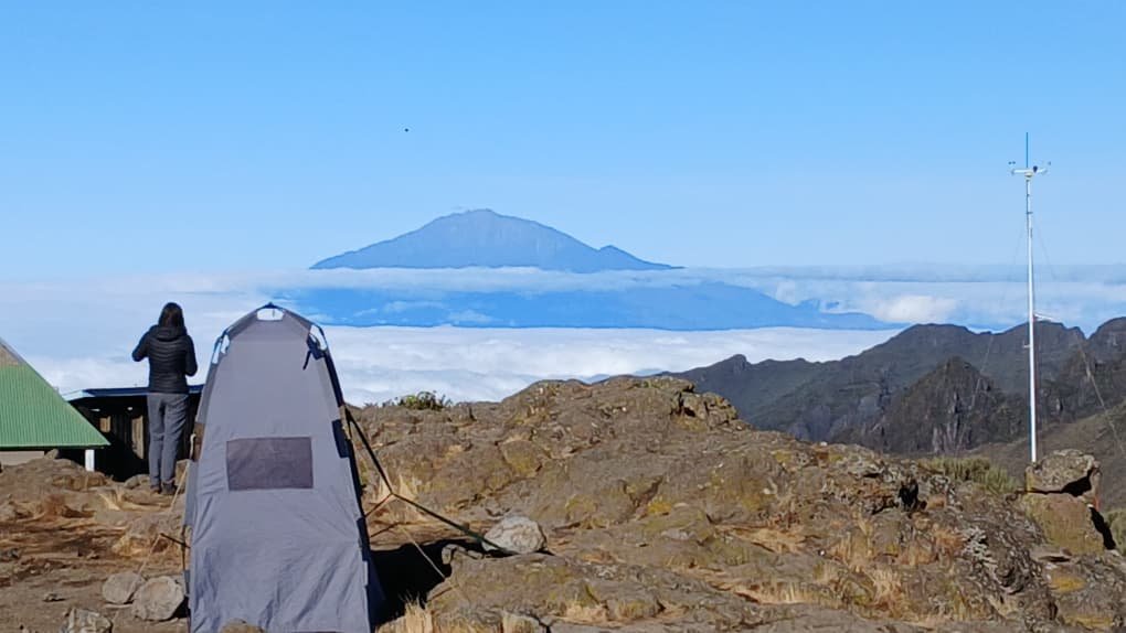 Mount Kilimanjaro rising above the clouds, seen from camp